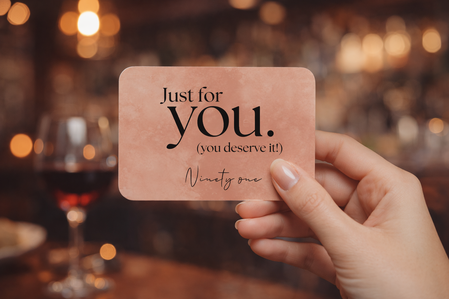 Just for You gift card held up in a wine bar