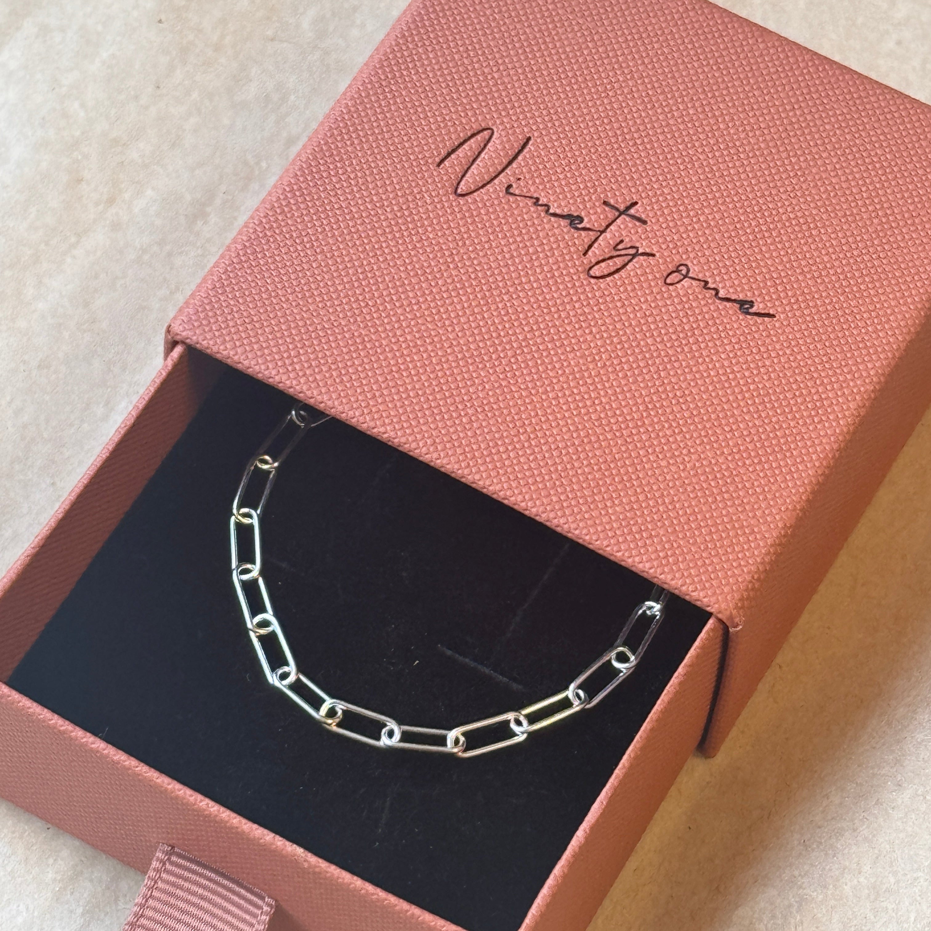 Silver bracelet in a pink box with 'Ninette' branding.